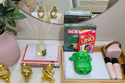 a table with books and other items on it at Payapa Staycation by DC in Manila