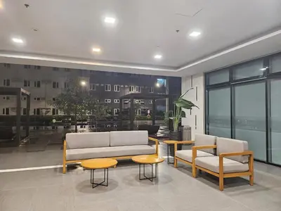 a living room with a couch and two chairs and tables at MZ Suite Home at SMDC Charm Residences in Manila