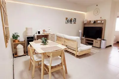 a living room with a table and a couch at Helaena's Scandi Haven in Manila