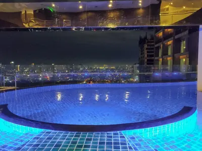 a swimming pool on the roof of a building with a city at Studio in Makati - Fast WiFi, Big Balcony, Pool and Gym Access in Manila