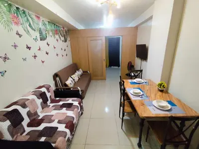 a living room with a couch and a table at Staycation In front of Mall of Asia Triple M in Manila