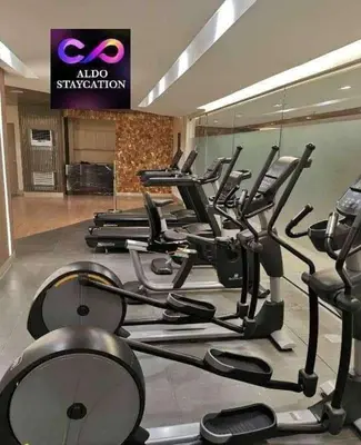 a gym with a bunch of cardio machines at Mall of Asia Pasay Shore 3 residences 2 in Manila