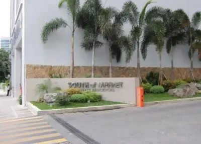 a sign in front of a building with palm trees at Elegant Family Retreat in the Heart of BGC in Manila