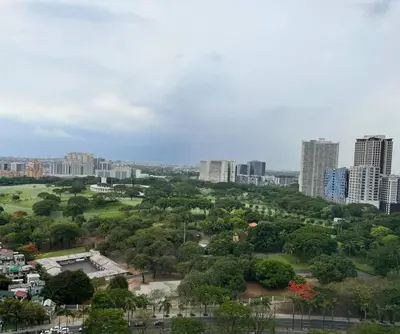 a view of a city with tall buildings and trees at Elegant Family Retreat in the Heart of BGC in Manila