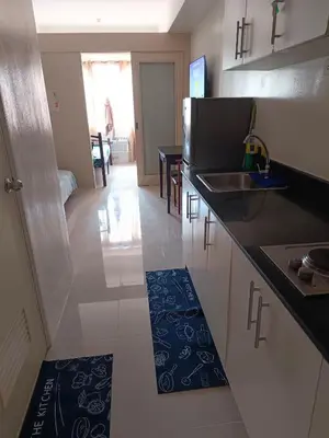 a kitchen with a sink and a counter top at Mall of Asia Sea Residences AMY'S Staycation in Manila