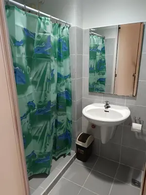 a bathroom with a shower curtain and a sink at Mall of Asia Sea Residences AMY'S Staycation in Manila