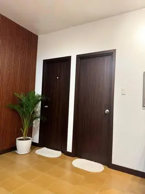 a room with two doors and a potted plant at Ram's crib at san lorenzo's place condo in Manila