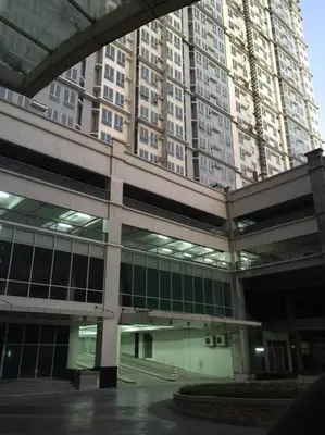 a large building with tall buildings in the background at Ram's crib at san lorenzo's place condo in Manila
