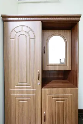 a wooden cabinet with a window and a door at Ram's crib at san lorenzo's place condo in Manila
