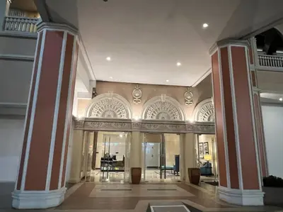 a large lobby with columns and tables in a building at Casa Feliza Belle-veranda overlooking Venice Grand Canal Gondola ride, with pool,gym,tennis,basketball courts,sauna and massage room in Manila