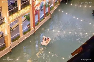 a couple on alatable raft in the water at a theme park at Casa Feliza Belle-veranda overlooking Venice Grand Canal Gondola ride, with pool,gym,tennis,basketball courts,sauna and massage room in Manila