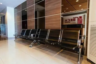 a row of empty benches in a building at Urban Deca Tower OYO in Manila