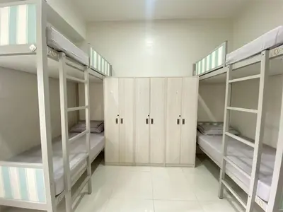 a room with four bunk beds in it at UHome Lacson in Manila