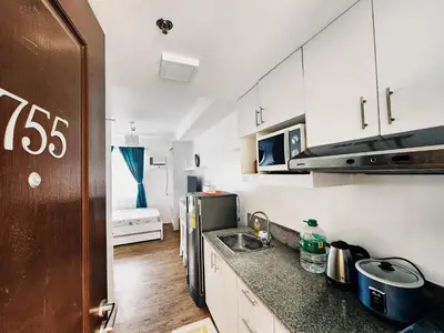 a small kitchen with a sink and a microwave at Mannah's Place in Santo Domingo
