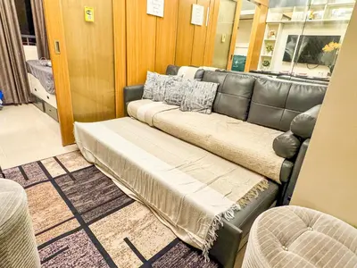 a bench in a room with a leather couch at 826 Air Condo Comfort Suite Spacious 1BR in Manila