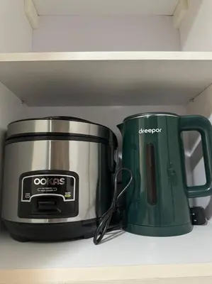 a toaster and coffee pot sitting on a shelf at Cozi Chic 1br Condo beside One uptown Mall BGC in Manila
