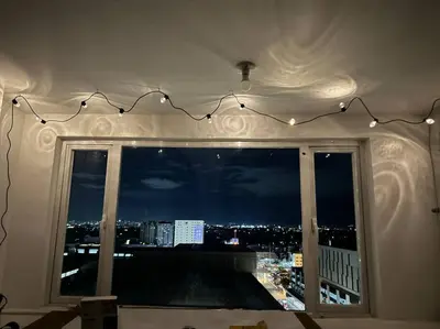 a window with a view of a city at night at Las Pinas City Cozy Escape in Manila