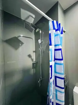 a bathroom with a shower with a shower curtain at 1 Bedroom Condo in Makati City in Manila