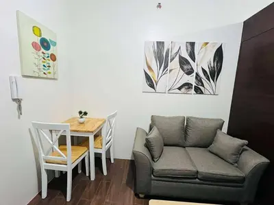 a living room with a couch and a table at 1 Bedroom Condo in Makati City in Manila