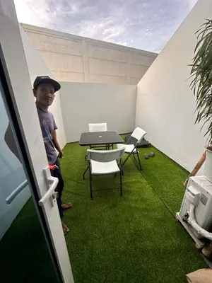 a young boy standing in a room with green grass at Cozy Brio the 2nd Sm Jazz Makati in Manila