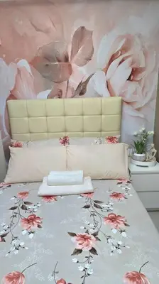 a bedroom with a bed with a flower wall at Shore 2 Tower 3 Condo near MOA by Dei Gratia in Manila