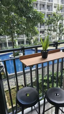 a balcony with a table and two stools at Shore 2 Tower 3 Condo near MOA by Dei Gratia in Manila
