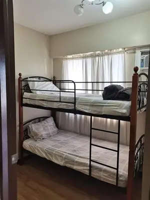 two bunk beds in a room with a window at 3BR Condo Unit at Mirea Residences in Manila