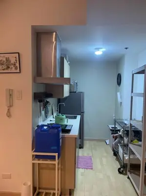 a kitchen with a counter top in a room at SOHO Central 1 Bedroom with Balcony near MRT EDSA SHAW PIONEER Greenfields SM Megamall Ortigas in Manila