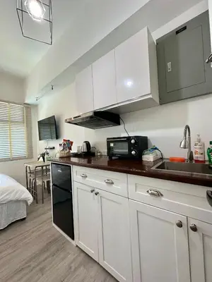 a kitchen with white cabinets and a sink at Studio One Condominium, Alabang - Bluu - Fiber Wi-Fi, Netflix-ready in Manila