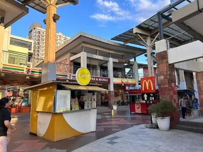 a shopping center with a mcdonalds in a city at Studio One Condominium, Alabang - Bluu - Fiber Wi-Fi, Netflix-ready in Manila