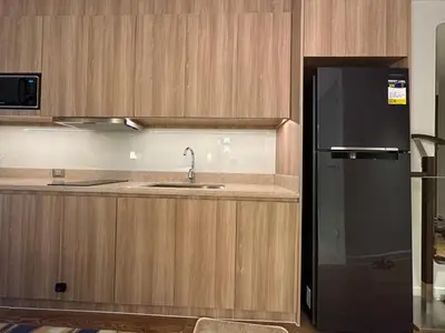 a kitchen with a sink and a refrigerator at The Hotel at Tower Acqua 1 in Manila