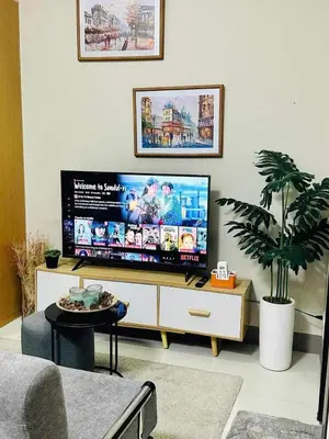 a living room with a large flat screen tv at Taguig Parksuit 1BGC in Manila