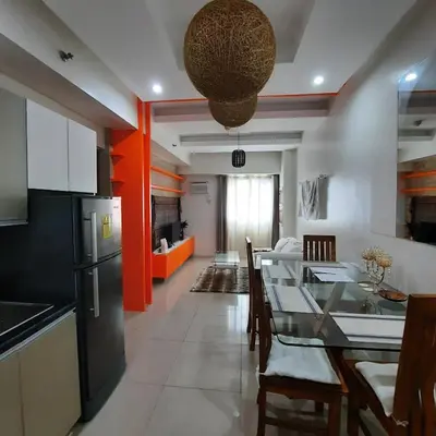 a kitchen and dining room with a table and chairs at Quaint One Br Apartment in Manila