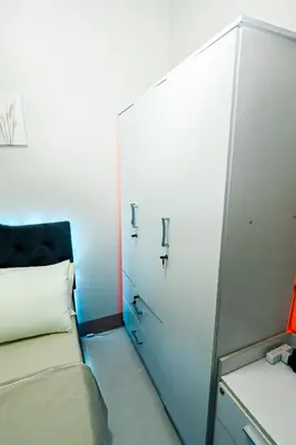 a small room with a bed and a mirror at Sapphira Manor Luxurious Condo by the Bay in Manila