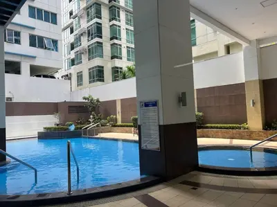 a large swimming pool in the middle of a building at QUITE Euro Luxe 3BR 7 mins walk to high street in Manila