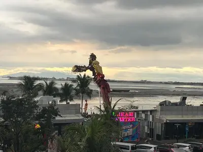 a statue of a man standing on top of a city at Gentry Manor Family Suite Balcony City View WiFi Netflix close to Okada 12B in Manila