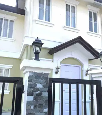 a white house with a black gate and a garage at Modern Home Near MOA and NAIA in General Trias
