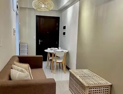 a living room with a couch and a table at Uptown BGC in Manila