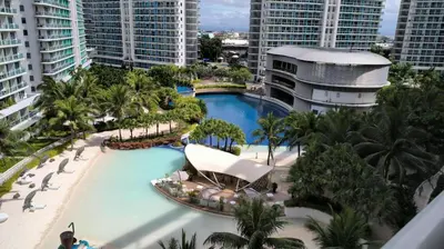 an aerial view of the pool at the paradiso resort at Aesthetic Beach View Unit in Azure Parañaque in Manila