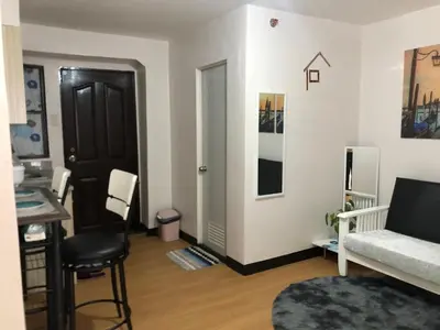 a living room with a couch and a table at Simple Living in Anabu Primero