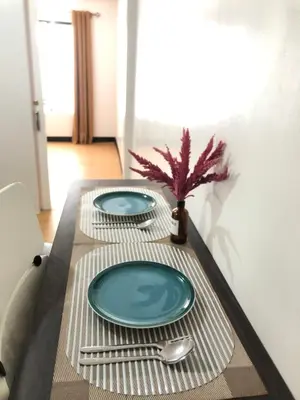 a table with two plates and a fork and knife at Simple Living in Anabu Primero