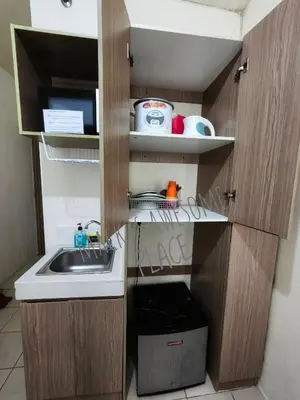 a small kitchen with a sink and a counter at Macks Awesome 12 Place Fast Wifi Netflix in Manila