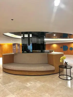 a large couch in a lobby with a table at Shore 2 Residences MOA DMBV in Manila