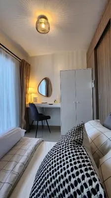 a bedroom with a bed and a desk with a chair at The New Villa at Shore 2 Residences in Manila