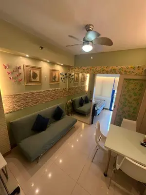 a living room with a couch and a table at MOA Sea Residence - Oasis MNL in Manila