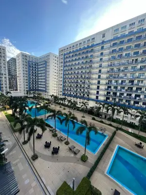 an aerial view of a large building with palm trees at MOA Sea Residence - Oasis MNL in Manila