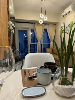 a dining room table with a tray of food on it at Stylish 1BR Near Airport Facing the Bay - 9d in Manila
