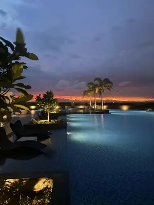a view of a pool at a resort at night at Stylish 1BR Near Airport Facing the Bay - 9d in Manila