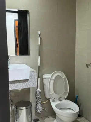a bathroom with a white toilet and a sink at Panoramic Seaview 2BR Near Airport Facing the Bay - 7g in Manila