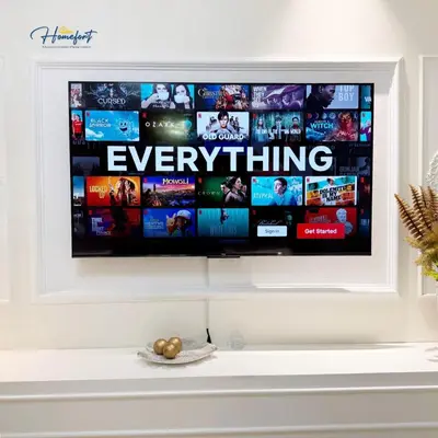 a flat screen tv on a white wall at Homefort at Lush Residences Makati in Manila